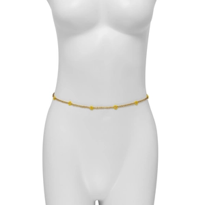 Detailed macro view of handmade yellow daisy beads on a gold body chain for women