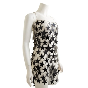 Detailed view of black star-shaped sequins and metal chain mesh body jewelry