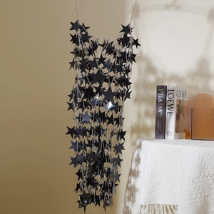 Detail of black star sequin body chain with silver links for party and festival fashion