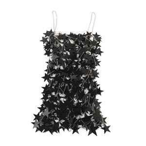 Detailed view of black star-shaped sequins and silver chain link body chain top
