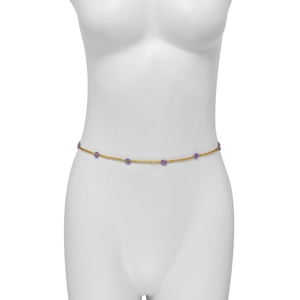 Detail of yellow handmade beaded waist chain with purple flower accents on a white mannequin
