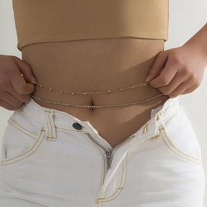 Detailed view of gold beaded and silver rhinestone double layer body waist chains on waist