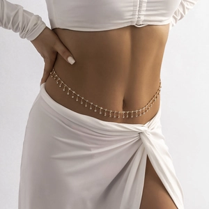 Close-up of golden waist chain with delicate rhinestones on a woman's midriff