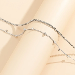 Detail of silver double-layered hip hop waist chain with sparkling square crystals