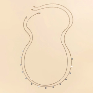 Detail showing double-layered silver waist chain with round sequins and lobster clasp