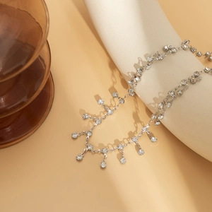 Detailed close-up of silver chain with hanging rhinestones and elegant tassels