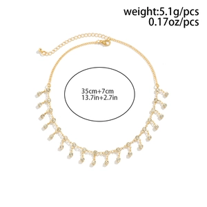 Detailed view of golden rhinestone fringe waist chain with adjustable lobster clasp