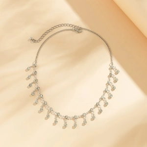 Detail of silver body chain featuring sparkling rhinestone pendants and lobster clasp