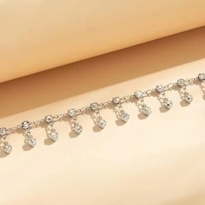 Close-up of silver rhinestone tassel waist chain with round cut crystal pendants