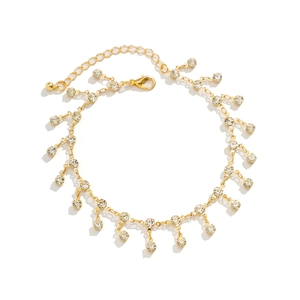 Detail of adjustable gold body chain with shimmering round rhinestone fringe tassels