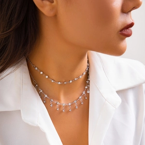 Close-up of silver bikini body chain with sparkling zircon pendants on a model