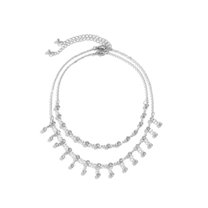 Detailed macro view of silver layered body chain with rhinestone pendants and lobster clasp