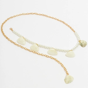 Detail of gold metal waist chain with white faux pearls and natural shell pendants