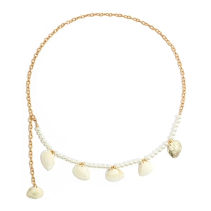 Detail of beaded body chain featuring gold metal links, white pearls, and seashell charms