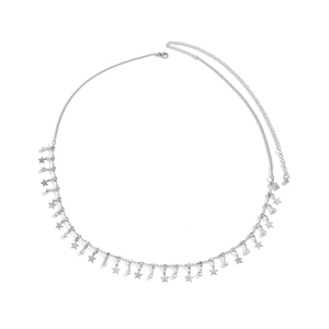 Detail of silver body chain with rhinestone fringe and matte star charms on white background