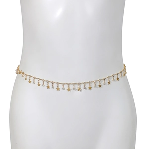 Detail of gold waist chain with rhinestones and star pendants on a model