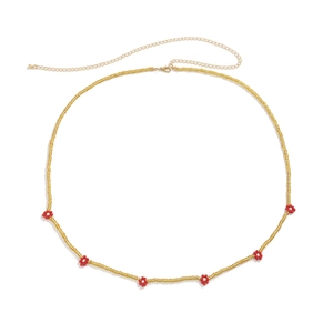 Close-up of bohemian waist chain with red bead flowers and gold adjustable lobster clasp