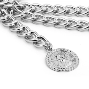 Macro shot of silver body chain featuring an Elizabeth II coin pendant and thick links