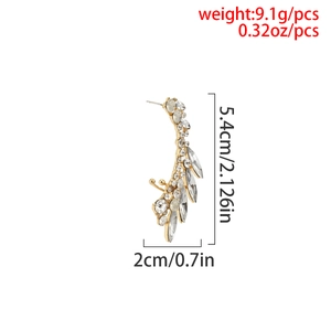 Macro view of gold crystal ear cuff showing dimensions 5.4cm by 2cm and 9.1g weight