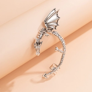 Detail of vintage silver dragon ear cuff with intricate scales and rhinestone accents