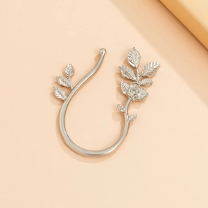 Detail of silver leaf and rose ear cuff with rhinestones and elegant metallic finish