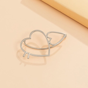 Detail of silver dual hollow heart hair clip with minimalist metal aesthetic design