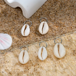 Detail view of five natural cowrie shell hair rings with silver metal hoops for braids
