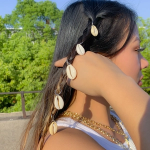 Bohemian style shell hair rings on braided hair for women with summer beach aesthetic
