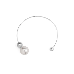 Detailed view of silver open collar necklace with round white pearl and metallic beads