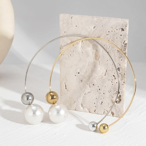 Minimalist asymmetrical geometric torque necklace with pearl and metal ball design