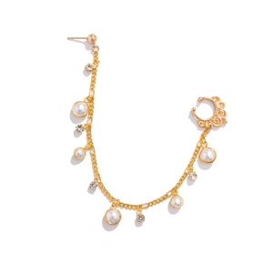 Detailed view of bohemian gold chain earring with white pearls and sparkling rhinestones