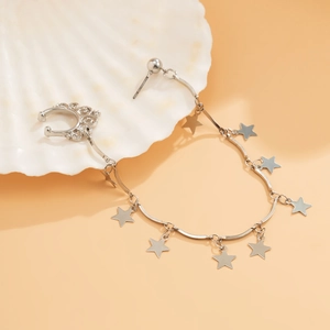 Detailed shot of silver star fringe ear cuff with chain and studs on scallop prop