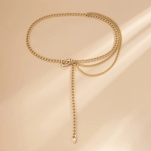 Detail of a gold multilayer metal waist chain belt with cascading fringes and adjustable clasp