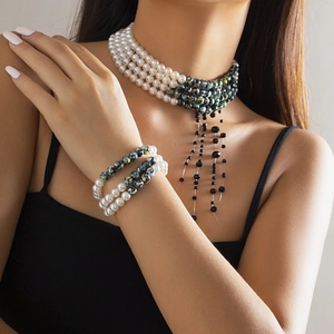 Detail of layered beaded choker necklace with gothic blood drip tassel and matching bracelets
