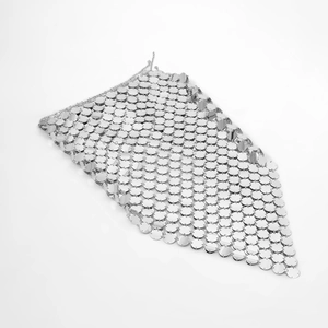 Macro detail of hand-assembled silver metal sequins and chainmail body chain links