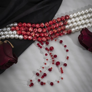 Close-up of gothic layered beaded choker with red blood-drop tassels and roses