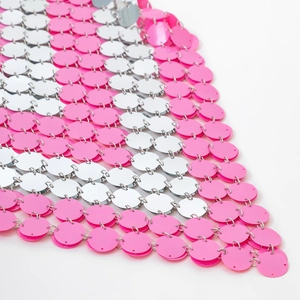 Detail of pink and silver sequins hand-linked with metal rings for a body chain skirt