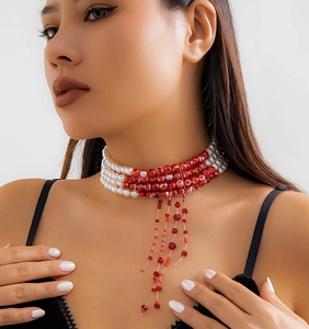 Close-up of triple-layer pearl choker with red blood droplet tassels for Halloween