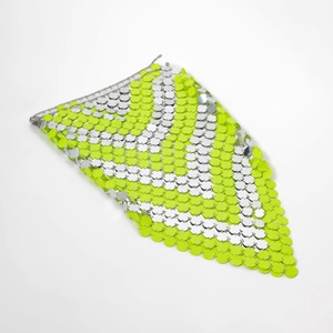 Close-up of neon yellow and silver sequins body chain with intricate metal link details