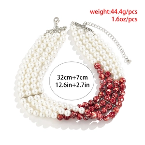 Macro view of four-layer beaded choker with red marble accents and adjustable silver clasp