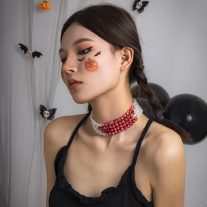 Close-up of gothic Halloween choker with multilayered beads and red blood drip effect