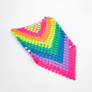 Detail of colorful rainbow sequins and metal rings on a sexy beach body chain skirt