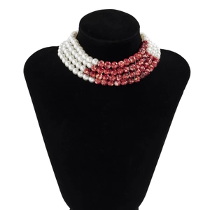 Detail of 5-layer choker necklace featuring white pearls and red marble texture beads