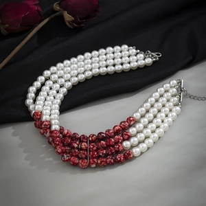 Detail of four-layer beaded choker with white pearls and gothic red blood-drip pattern beads
