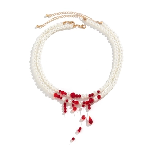 Detail of beaded gothic choker featuring white pearls and red blood-drop crystal tassels