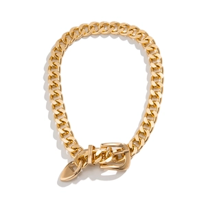Detail of chunky gold Cuban chain necklace with a buckle clasp and heart pendant