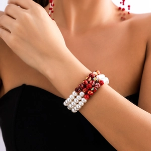 Detail of triple-layer beaded choker with red marble and white pearl beads on neck