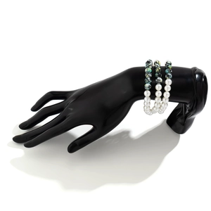 Close-up of a 3-piece beaded bracelet set featuring white faux pearls and speckled beads