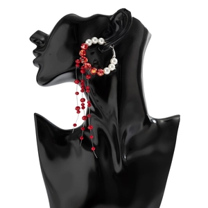 Gothic crystal fringe earrings featuring red glass beads and white pearls on a black model