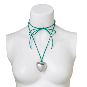 Detail of adjustable green suede cord necklace with a polished silver heart pendant